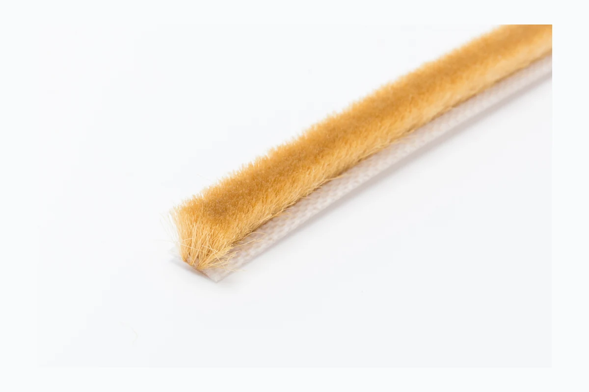 Real gold wool pile weatherstrip close-up